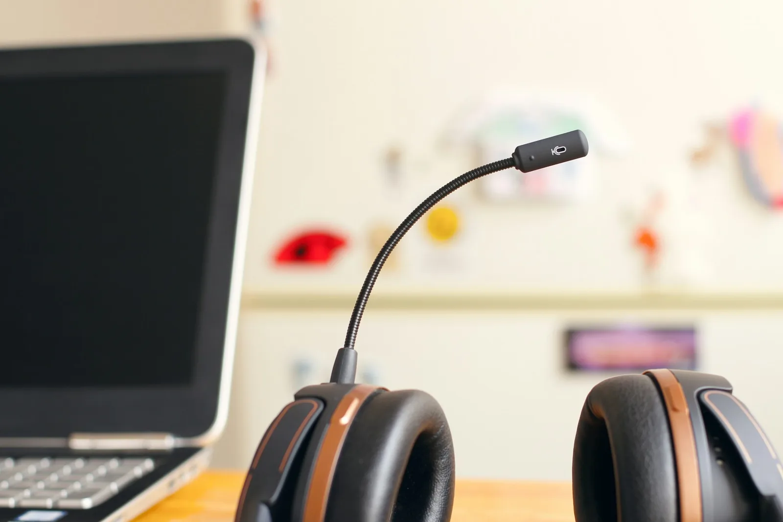 A headset next to a laptop